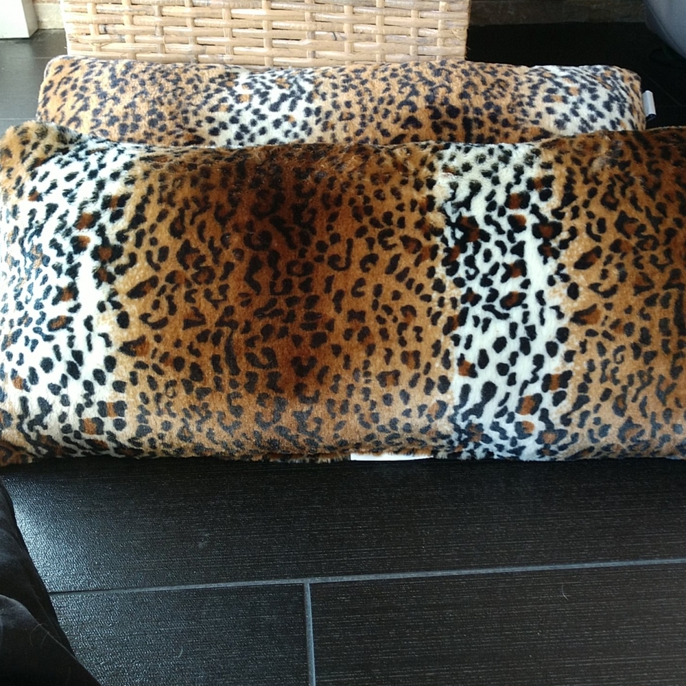 2 throw pillows 24 in by 11 in faux fur.